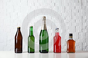 Bottles with different alcoholic drinks on table