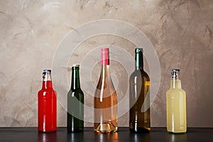 Bottles with different alcoholic drinks on table
