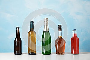 Bottles with different alcoholic drinks on table