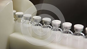 Bottles with drugs on the conveyor line in pharmaceutical factory