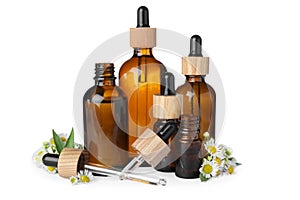 Bottles of essential oil and beautiful flowers on white background