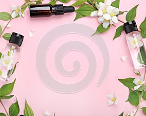 Bottles of essential oil with jasmine flowers photo