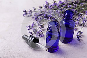 Bottles of essential oil and lavender flowers