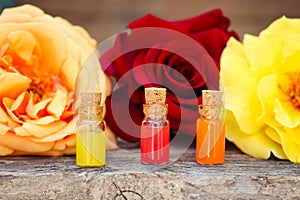 Bottles of essential oil and roses