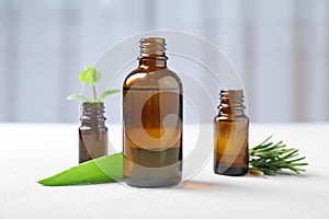 Bottles with essential oils and fresh herbs