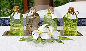 Bottles of essential oils placed on the bed decoration leelawadee flower.