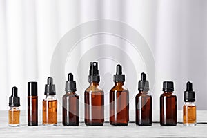 Bottles of essential oils on table. Cosmetic products