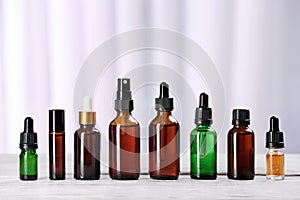 Bottles of essential oils on table. Cosmetic products
