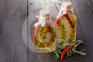 Bottles of extra virgin olive oil with aromatic herbs