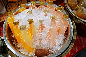 Bottles of fresh fruit juice. refreshments drinks orange juice and lychee juice were contained in plastic bottle and were chilled