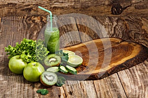 The bottles with fresh vegetable juices on wooden table