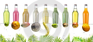 Bottles with fruit juices, sodas and tropical fruits on a white background.