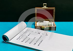 Bottles of glass homeopath medicine in open wooden box, rolled currency and notepad on blue and dark background -  Homeopathic