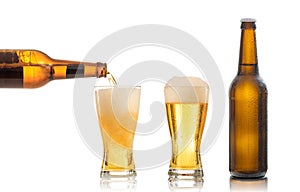 Bottles and glasses of beer on white background photo