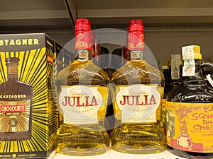 Bottles of grappa julia invecchiata on store shelf display