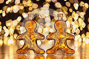 Bottles of homemade gingerbread syrup on light spotty background