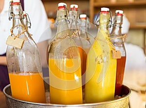 Bottles of juice in ice bucket at market