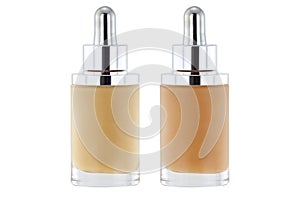 Bottles of liquid foundation with dropper in pink and yellow undertone photo