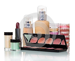 Bottles with liquid foundation, lip lipstick, rouge, cream jars isolated.