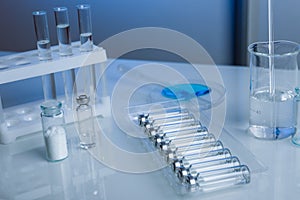 Bottles with liquid medicine on a table in a laboratory.