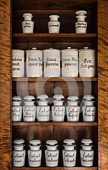 Bottles with medicines on the shelf in old pharmacy. Old pharmacy, medicine and chemistry background.