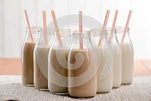 Bottles of milk with straws