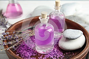 Bottles with natural herbal oil and lavender flowers