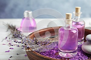 Bottles with natural herbal oil and lavender flowers