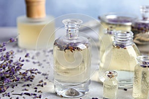 Bottles with natural herbal oil and lavender flowers