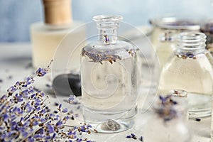 Bottles with natural herbal oil and lavender flowers