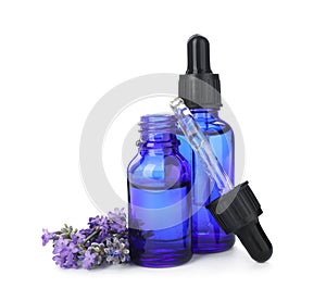 Bottles with natural lavender oil, flowers and dropper