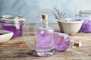 Bottles with natural lavender oil on table