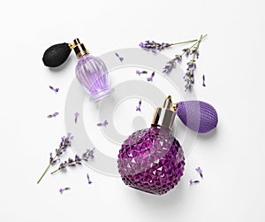 Bottles of natural perfume and lavender flowers on white background. Cosmetic products