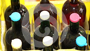 Bottles of old red wine with plastic closures