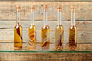 Bottles of olive oil with herbs and spices