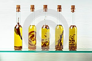 Bottles of olive oil with herbs and spices