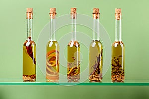 Bottles of olive oil with herbs and spices