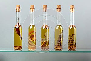 Bottles of olive oil with herbs and spices