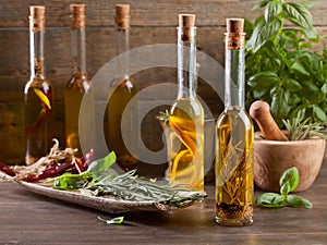 Bottles olive oil with various herbs and spices.
