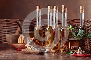 Bottles of olive oil with various spices and herbs