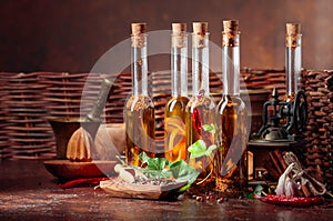 Bottles of olive oil with various spices and vintage cooking utensils