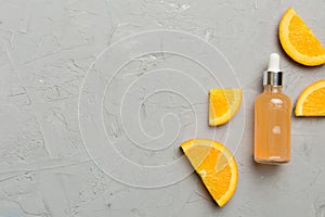 Bottles with orange fruit essential oil on wooden background. alternative medicine top view with copy space