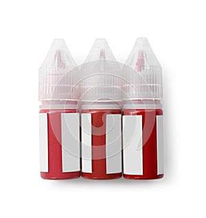 Bottles of pigments for permanent makeup isolated on white, top view photo