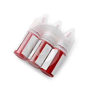 Bottles of pigments for permanent makeup isolated on white, top view photo