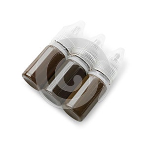 Bottles of pigments for permanent makeup isolated on white, top view photo