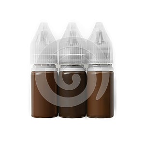 Bottles of pigments for permanent makeup isolated on white, top view photo