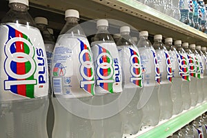 Bottles of 100Plus soft drink are displayed in market