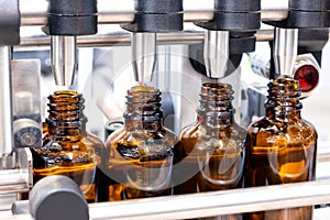 Bottles on the production line conveyor of the pharmaceutical industry. Machine for liquid drugs glassware bottling