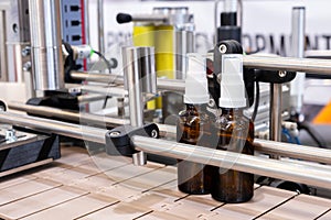 Bottles on the production line conveyor of the pharmaceutical industry. Machine for liquid drugs glassware bottling