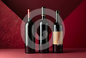 Bottles of red wine on a red background